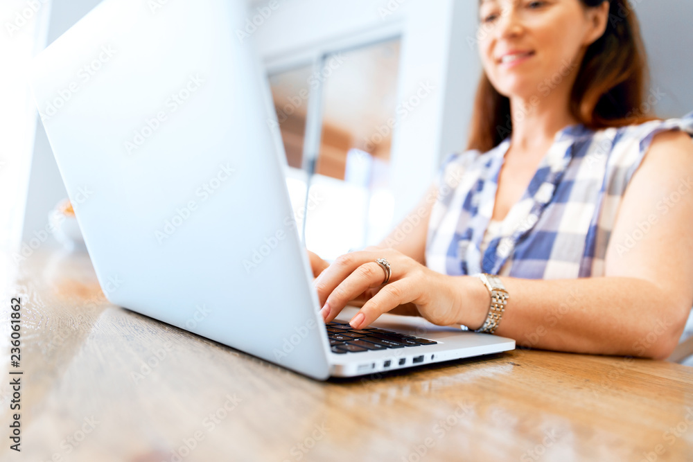 Mature beautiful woman working on her laptop Mature beautiful woman working on her laptop