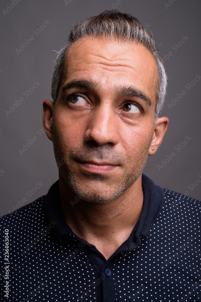 Obraz premium Face of handsome Persian man thinking and looking up