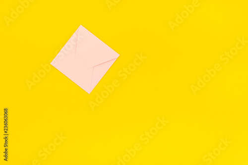 Pastel pink envelope on yellow background