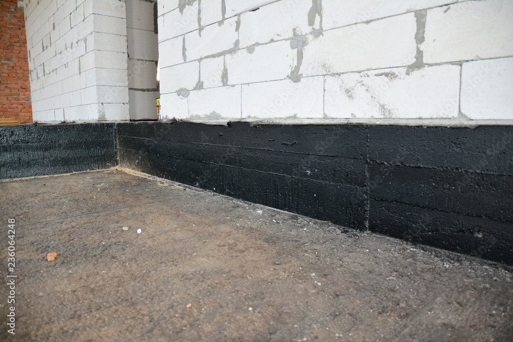 Foundation bitumen waterproofing. Building house construction with