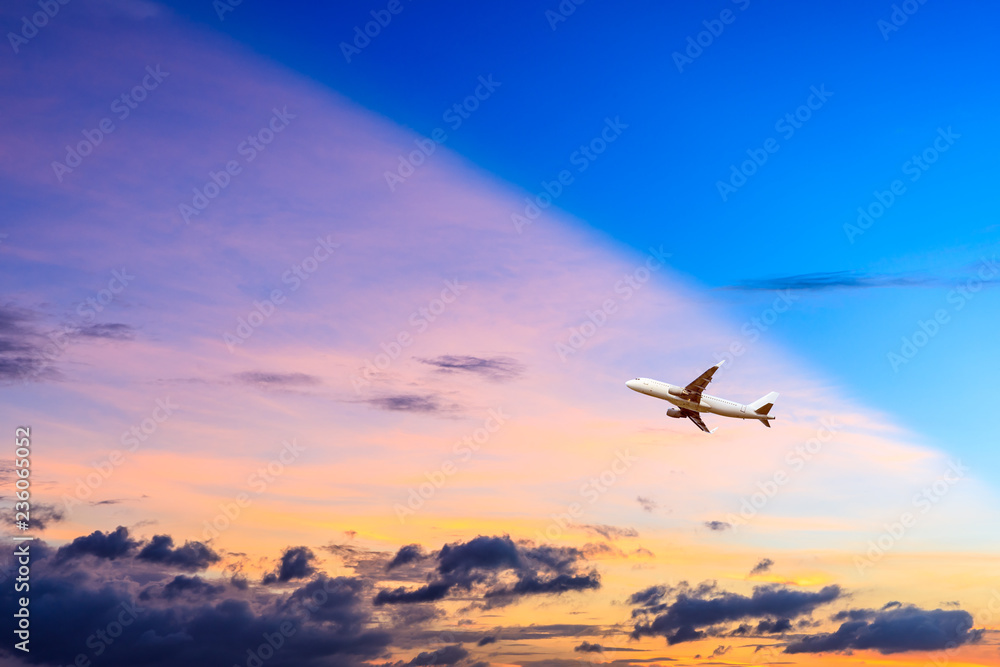 Airplane flying above dramatic clouds during sunset Airplane flying above dramatic clouds during sunset