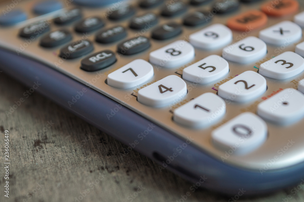 Close up of a white scientific calculator with a shallow depth of field Close up of a white scientific calculator with a shallow depth of field