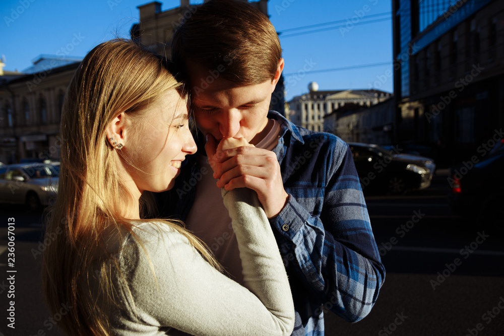happy couple hugging, kissing on the street in the city. date. we are alone in the world.kiss hand happy couple hugging, kissing on the street in the city. date. we are alone in the world.kiss hand