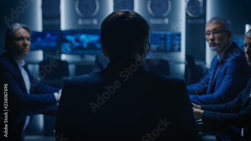 Chief Strategy Officer Making Report to a Board of Directors During Annual Financial Meeting in the conference Room. Business People / Politicians / Government Officials on a Meeting. photo