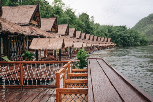 Old vintage planked wood table in Resort home raft floating, river kwai at sai yok,kanchanaburi,thailand photo