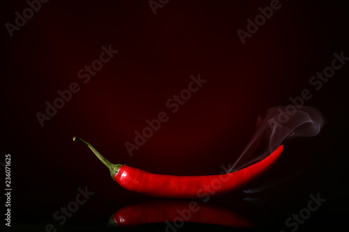 Red hot chili pepper on dark color background