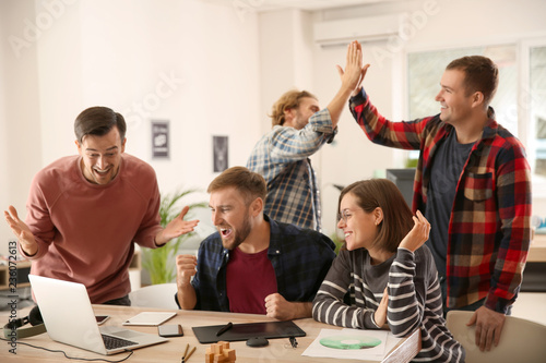 IT specialists finishing their job in time photo