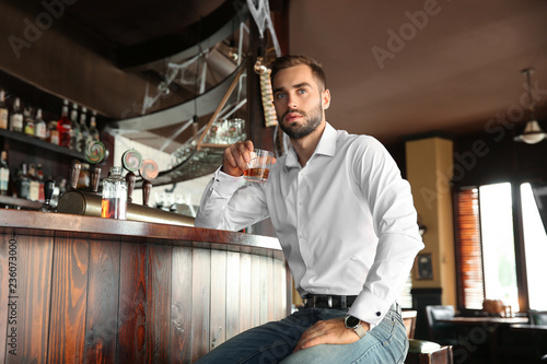 Young man drinking whiskey ...