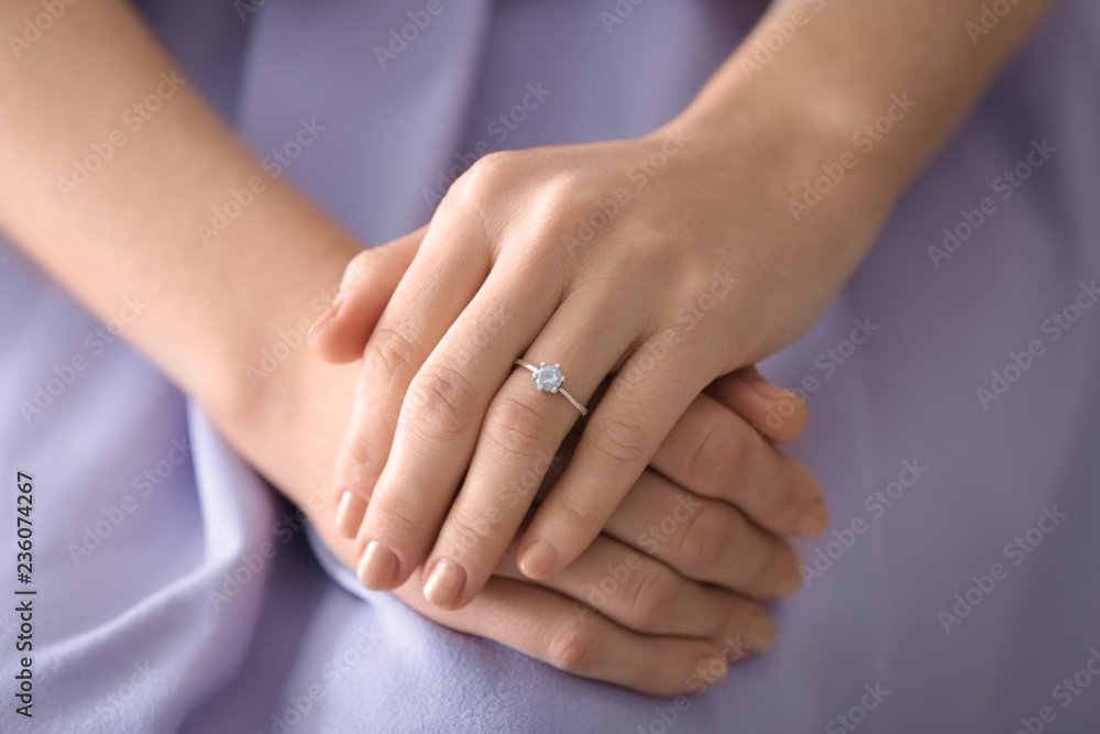 Young woman with engagement ring on her finger, closeup Young woman with engagement ring on her finger, closeup