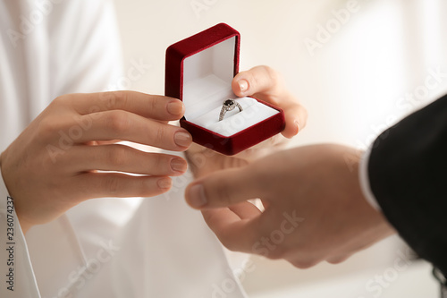 Young woman proposing to he...