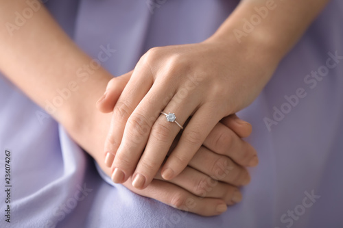 Young woman with engagement ring on her finger, closeup
