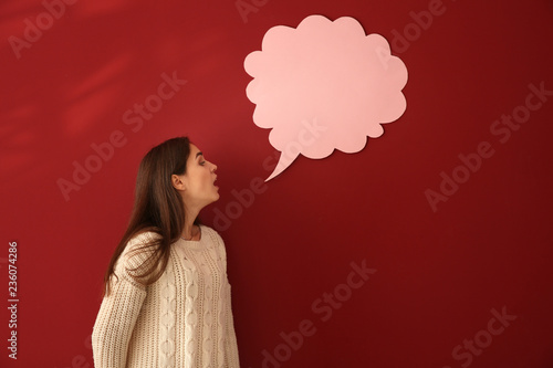 Young woman near blank spee...
