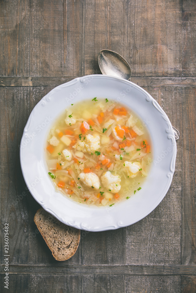 White plate of homemade vegetable soup, close up White plate of homemade vegetable soup, close up
