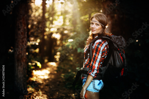 Beautiful and young woman hiking in forest