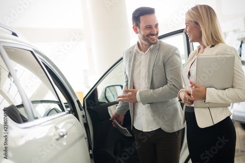 Portrait of happy customer buying new car