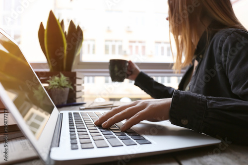 Woman using computer at tab...