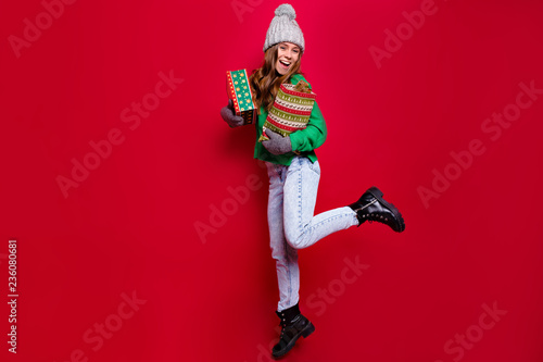 Full-lenght photo of jumping energy young lady wearing winter outfit with new year presents prepearing for winter holiday and celebration of new year