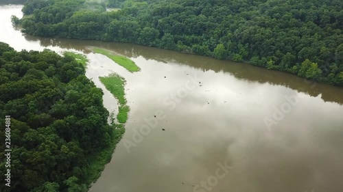 Forward shot over the water and the trees in the mountains photo