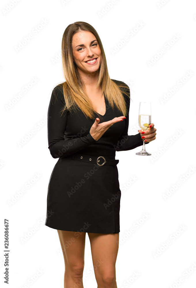 Woman with champagne celebrating new year 2019 presenting an idea while looking smiling towards on isolated white background Woman with champagne celebrating new year 2019 presenting an idea while looking smiling towards on isolated white background