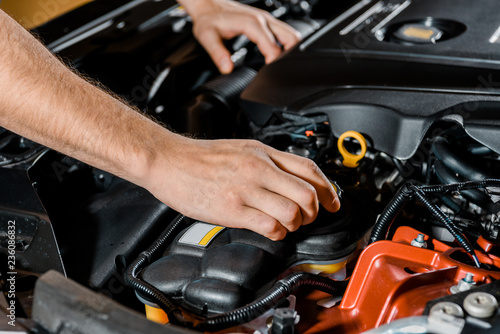cropped shot of auto mechanic checking automobile © LIGHTFIELD STUDIOS