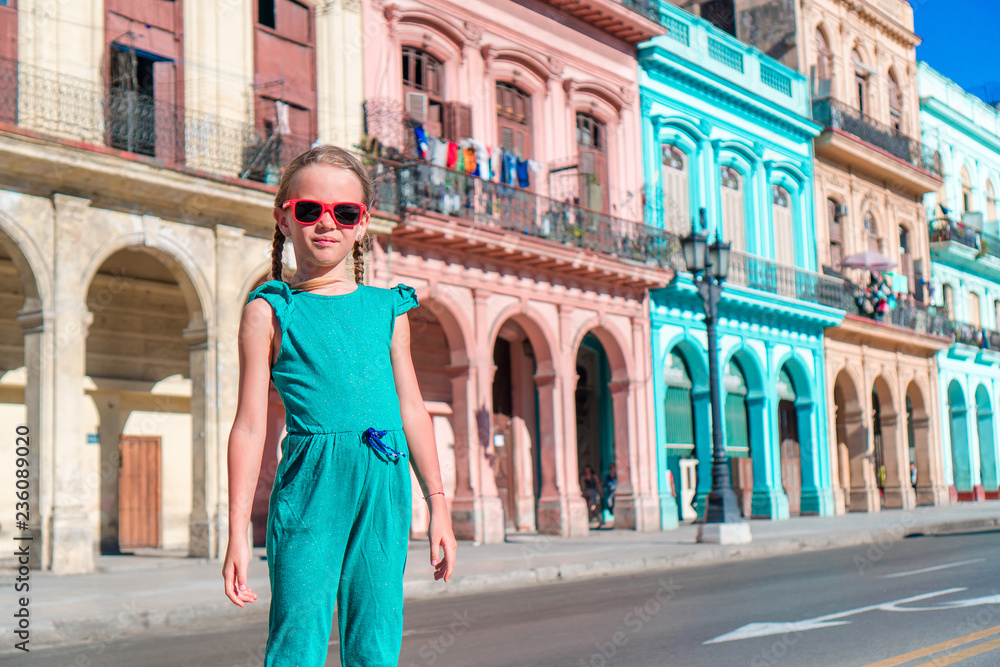Tourist girls in popular area in Havana, Cuba. Young woman traveler smiling
