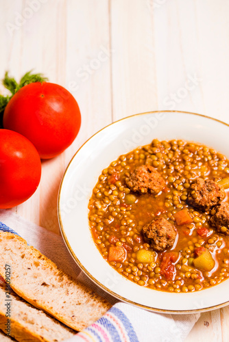 Lentil soup with fricandel, tomatoes and bread. Copy space