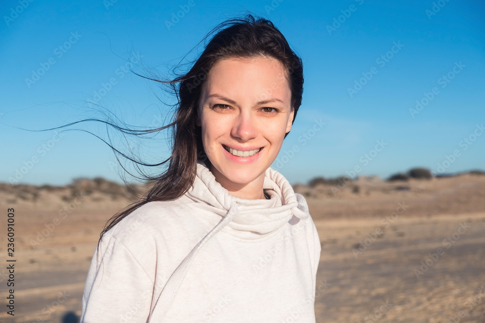 Beautiful brunette girl looking at the camera and smiling. Solar photography.