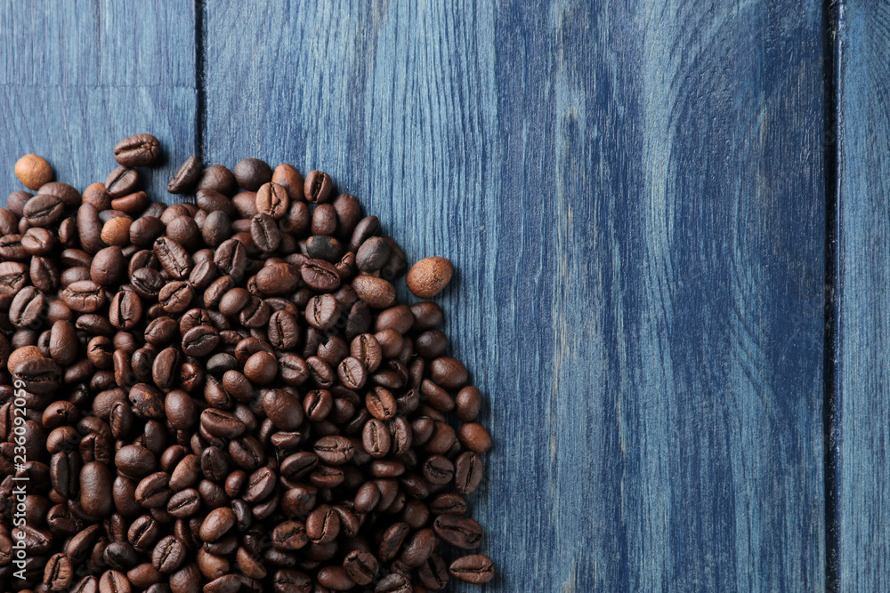 Frame of roasted coffee beans on a blue wooden table. view from above. space for text Frame of roasted coffee beans on a blue wooden table. view from above. space for text