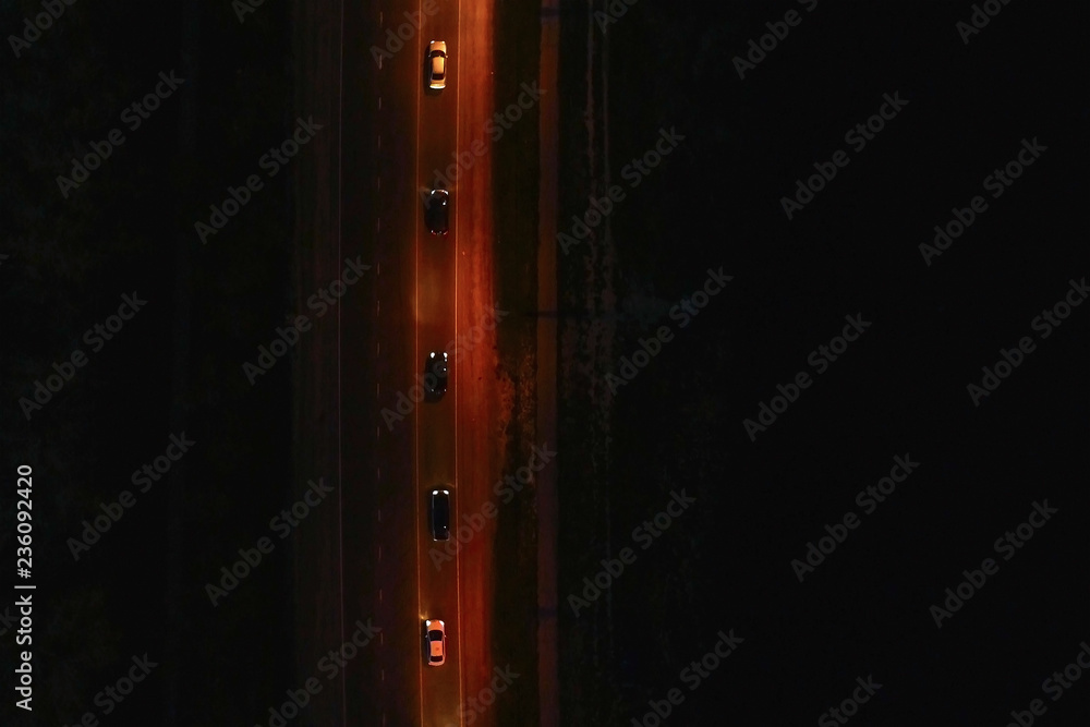 View over the roadway with cars at night. Beautiful aerial view on the night road. View over the roadway with cars at night. Beautiful aerial view on the night road.