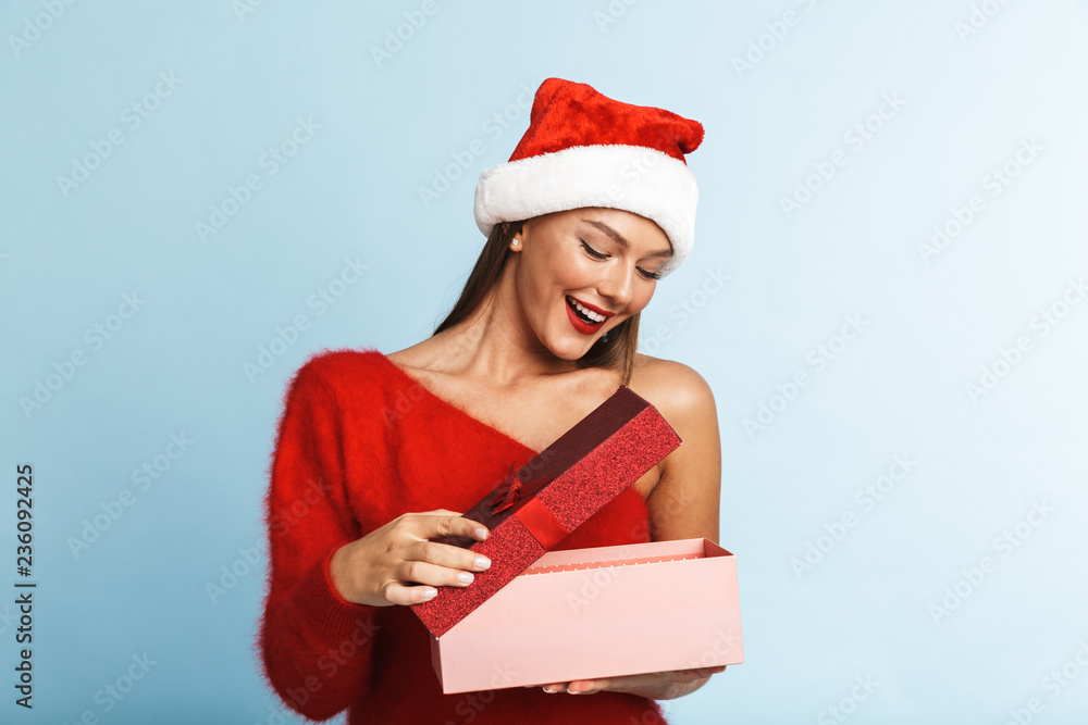 Excited young woman wearing red santa claus hat Excited young woman wearing red santa claus hat