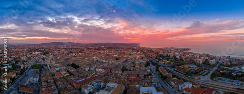 Aerial panorama of popular travel destination beach town Fano in Italy with sunset blue, red, purple sky near Rimini in the Marche region.
