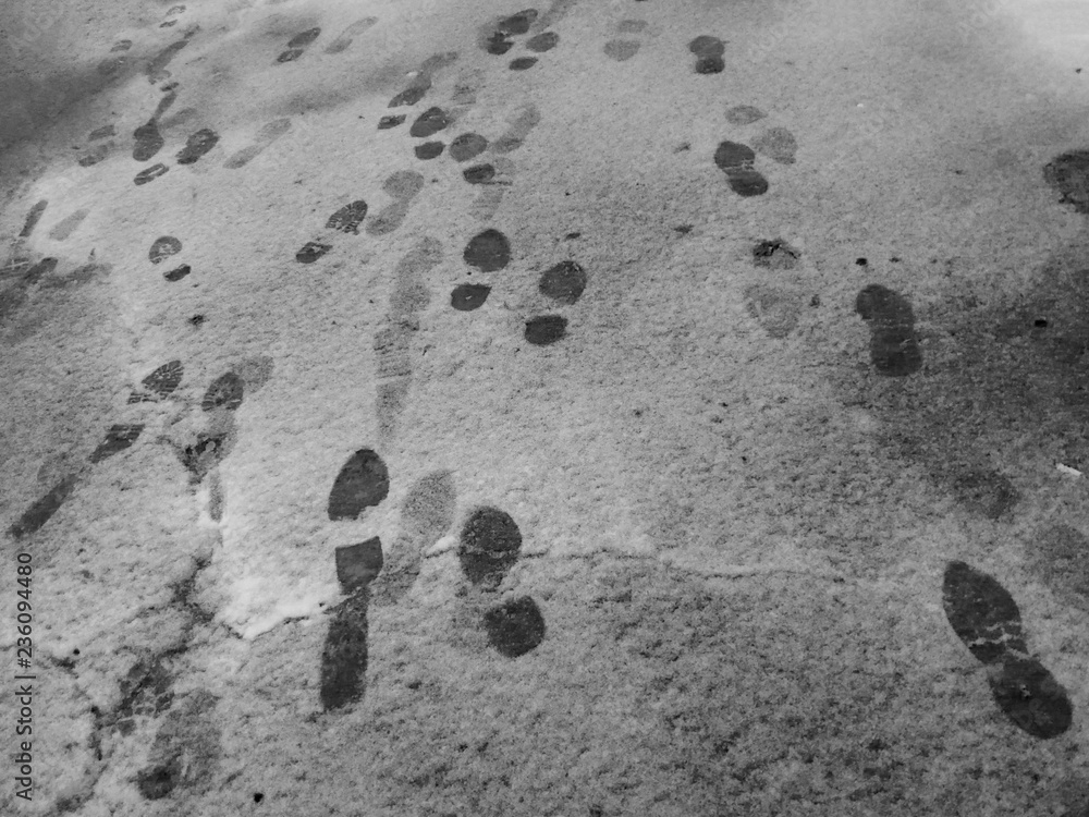 Footprints on the street in the snow in winter