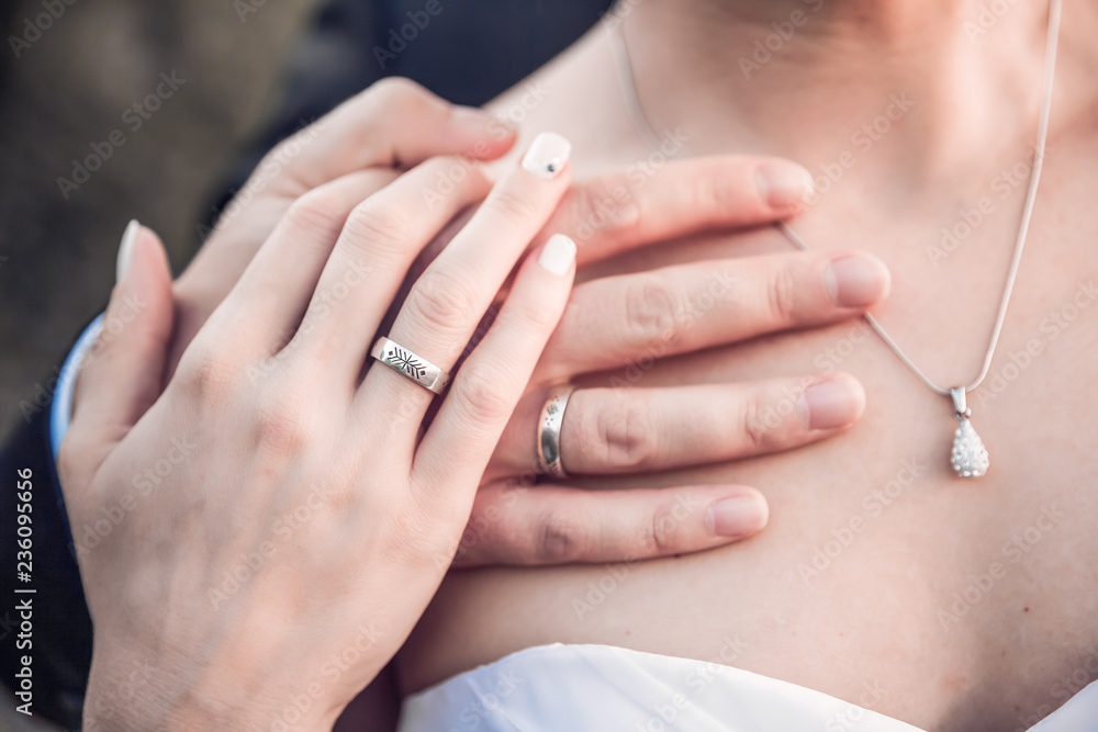 Image of hands on womens shoulder, wedding concept