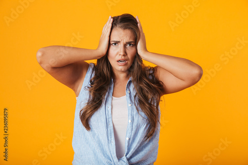 Shocked young woman standing isolated