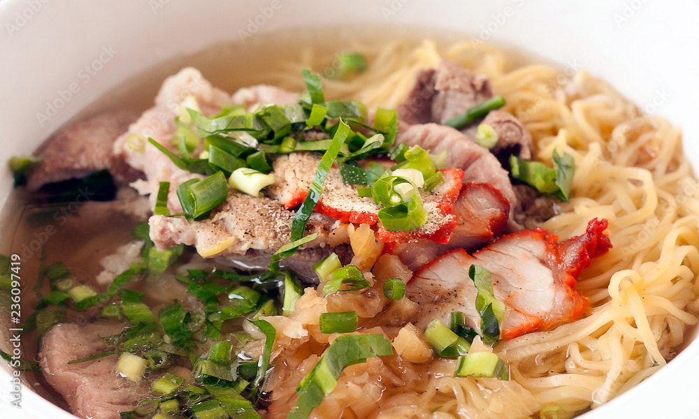 noodle soup with red pork and Pig liver on top celery,Onion,pepper noodles Traditional Thai Street Foods. noodle soup with red pork and Pig liver on top celery,Onion,pepper noodles Traditional Thai Street Foods.