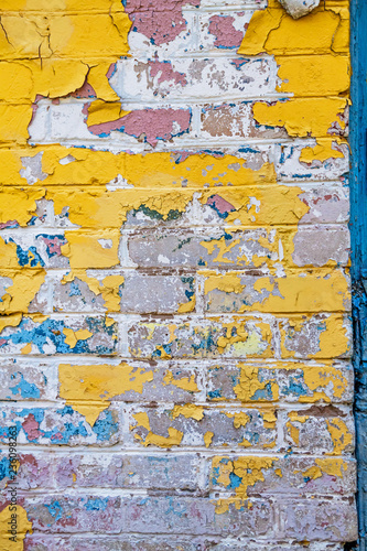 Cracked wall with old layers of paint in abandoned house