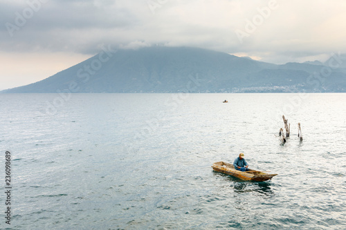 Fisherman in a boat on Lake Atitilan in Guatemala photo