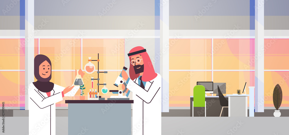 couple arabian scientists working with microscope laboratory doing research arab man woman making scientific experiments doctors in lab interior portrait workplace horizontal