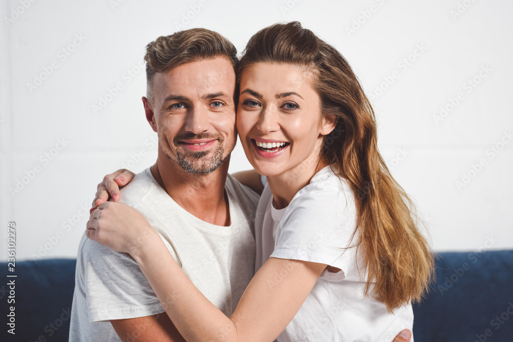 Happy husband and wife smiling and hugging Happy husband and wife smiling and hugging