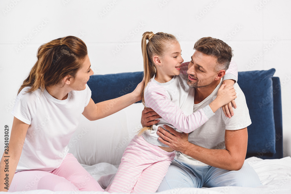happy family in pajamas hugging in bed happy family in pajamas hugging in bed