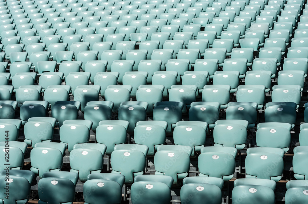 blue empty seats in a stadium on a sunny day blue empty seats in a stadium on a sunny day