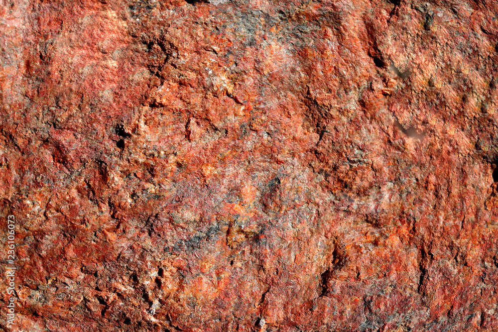 The structure of the natural is not polished granite red. Natural background, cropped picture, close-up. The concept of nature and production.