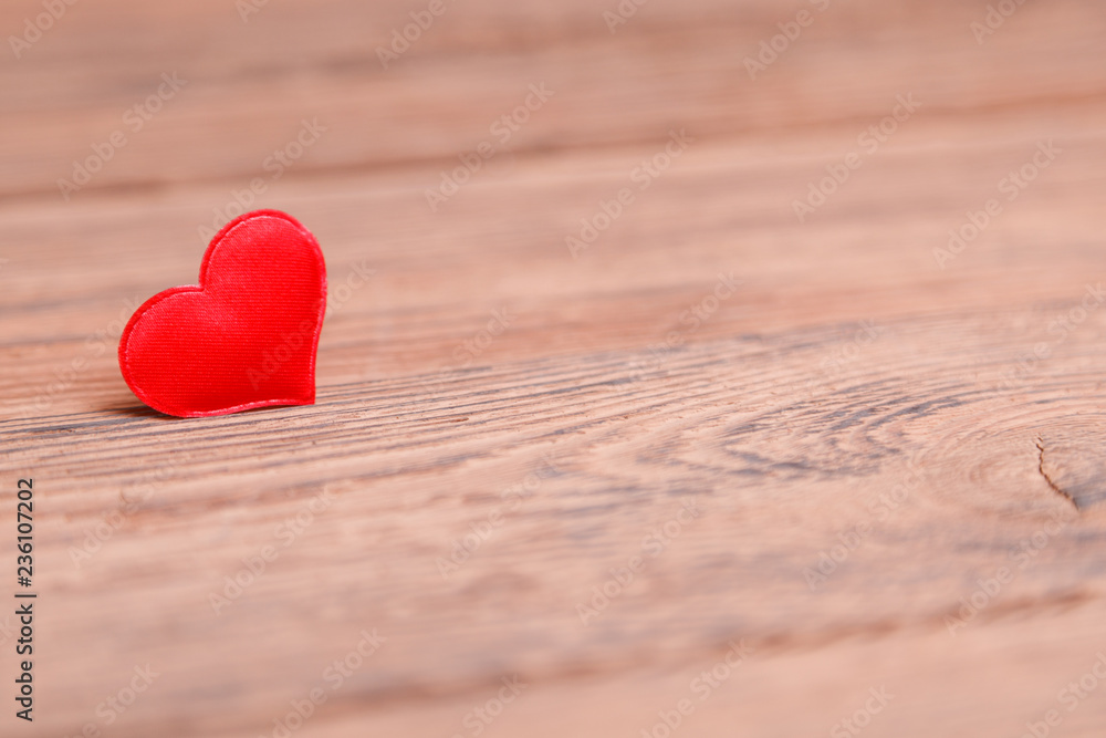Fototapeta premium Valentine's day red heart on wooden background. Holidays background. Love card. Selective focus