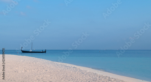 white sand beach and a sail boat over turquoise lagoon in Maldives © Fernando.RM