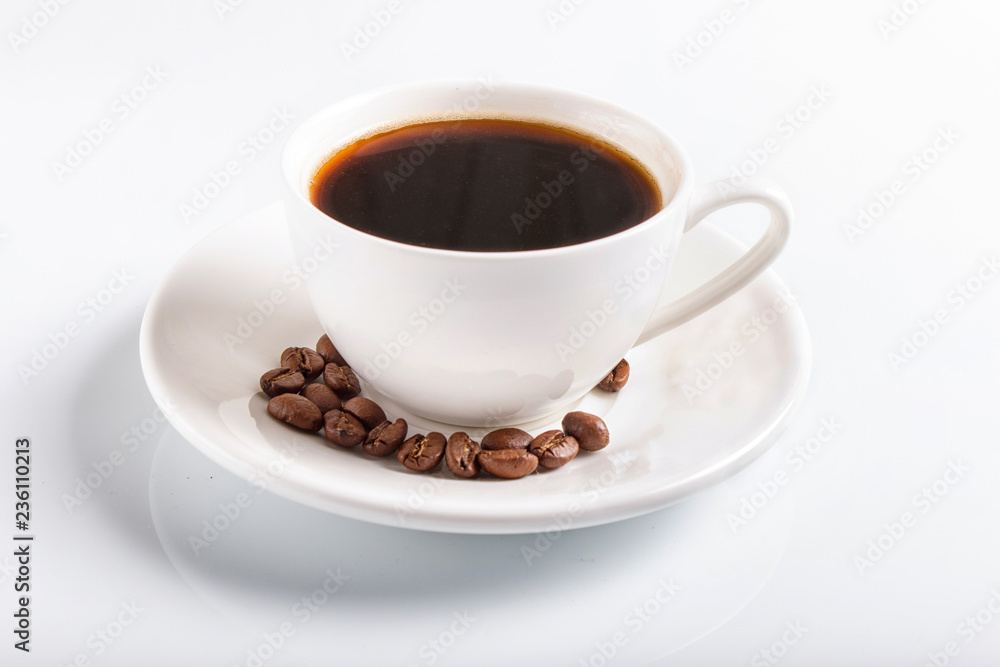 a cup of coffee with coffee beans on a plate, isolated on white. a cup of coffee with coffee beans on a plate, isolated on white.