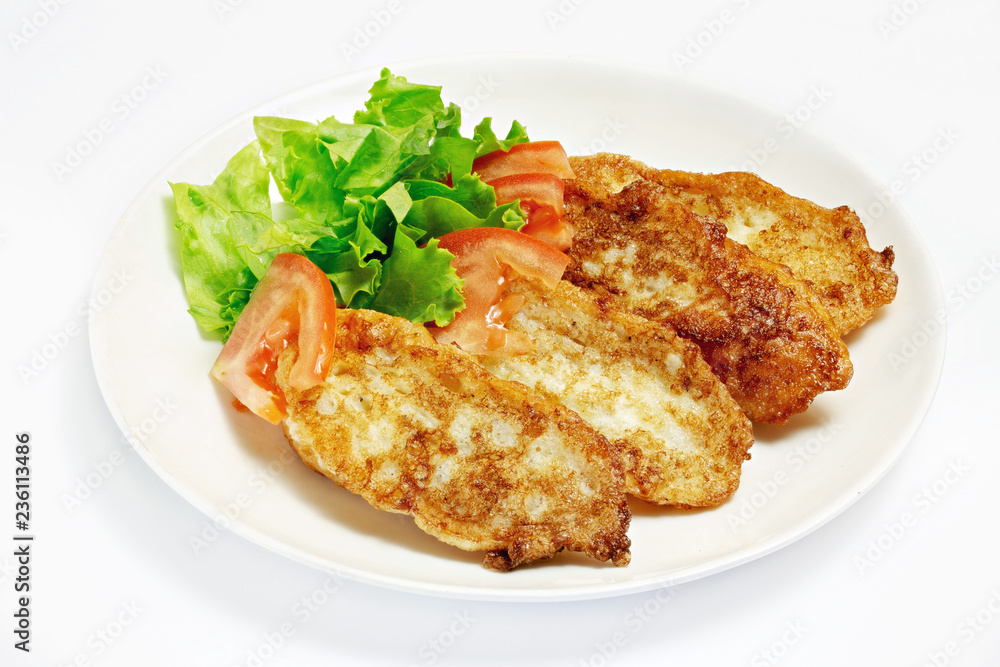 Roasted meat and vegetables on a white background