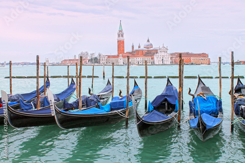 View of gondolas on Grand Canal and San Giorgio Maggiore church. Venice cityscape. Italy.