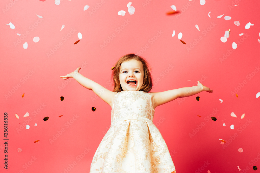 Studio shot of toddler girl throwing confetti Stock Photo Adobe Stock