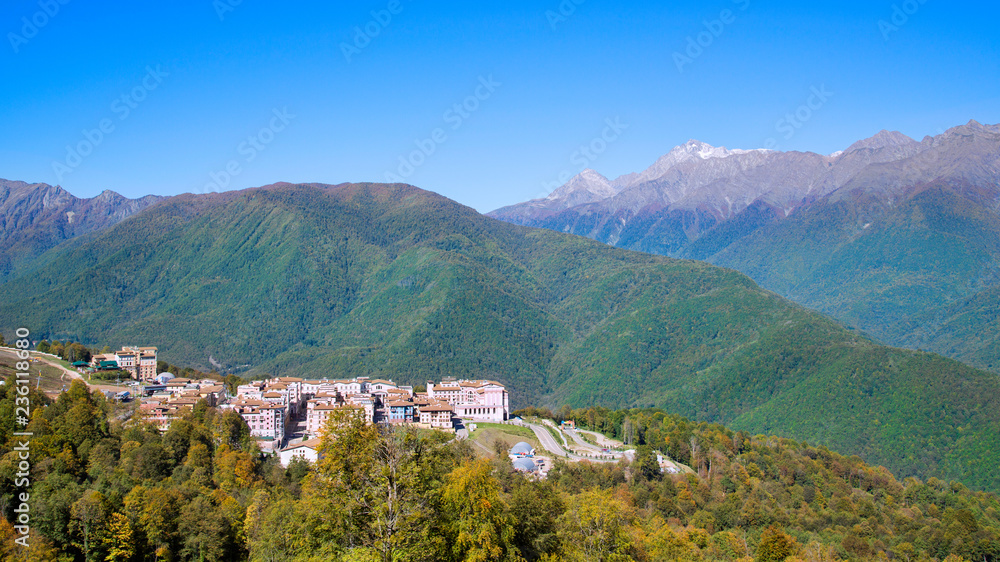 Small town in the mountains. Town in the mountains. City against the backdrop of mountains and forests.