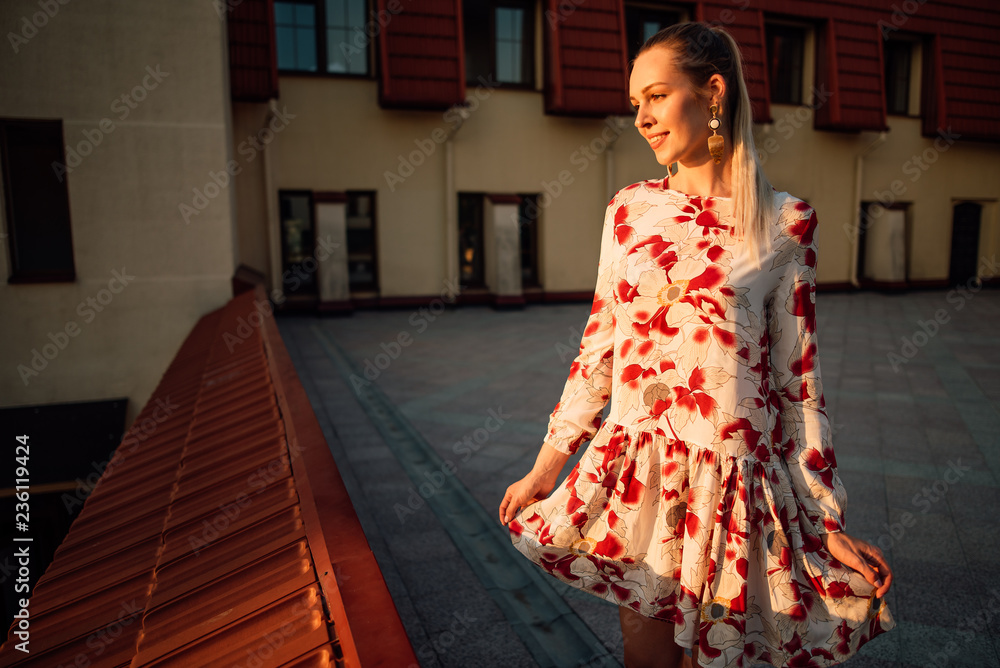 Obraz premium beautiful girl in a dress outdoors, amazing woman walking in the city at sunset